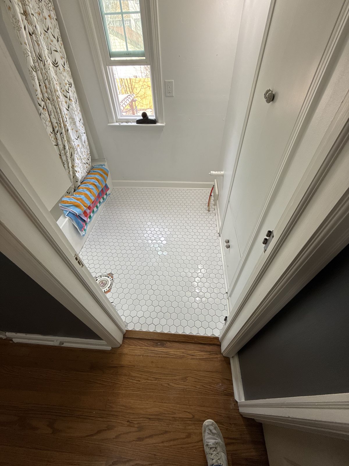 Finished bathroom with white hex tile floor