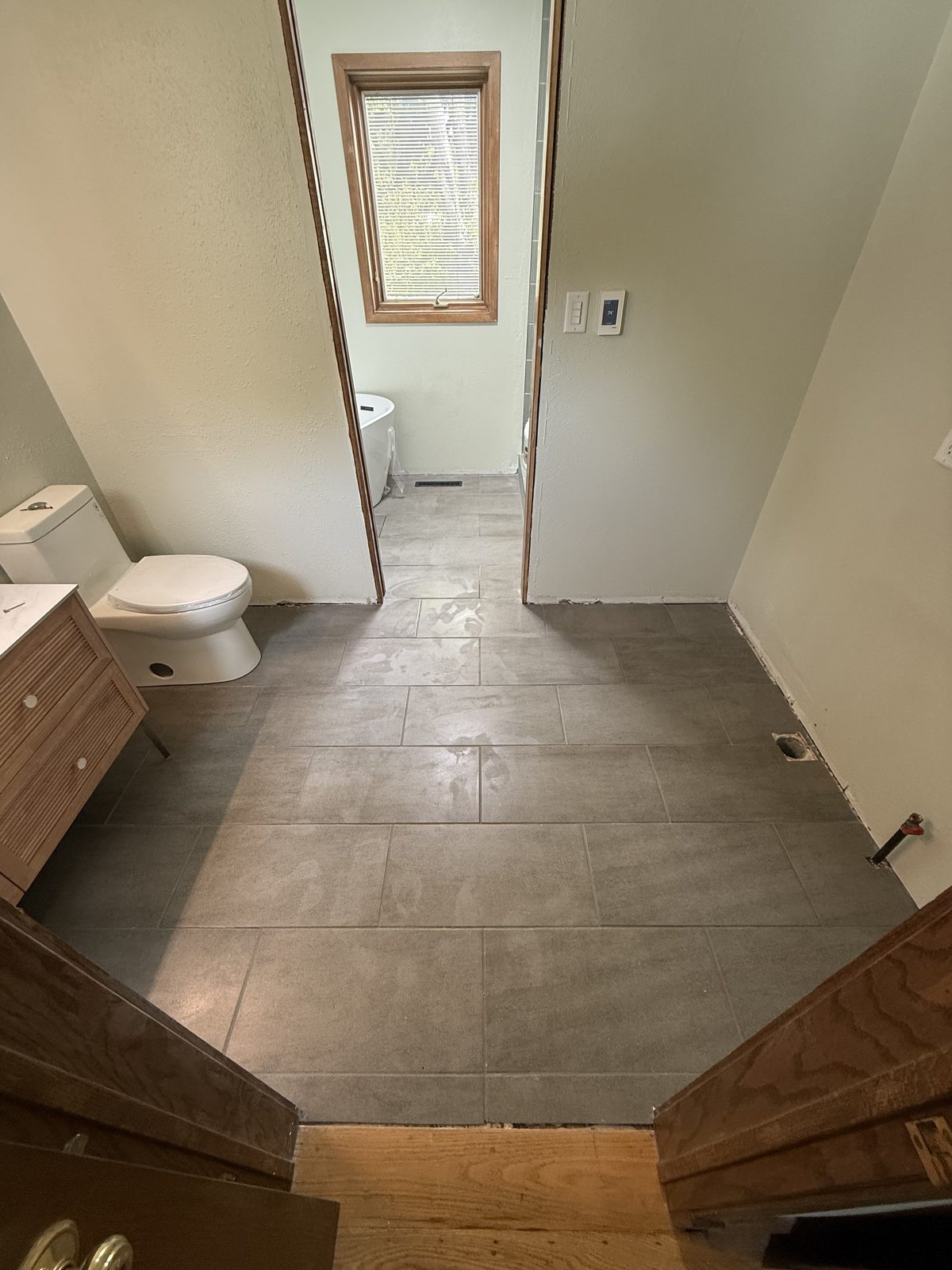 Large-format tile floor leveled and grouted